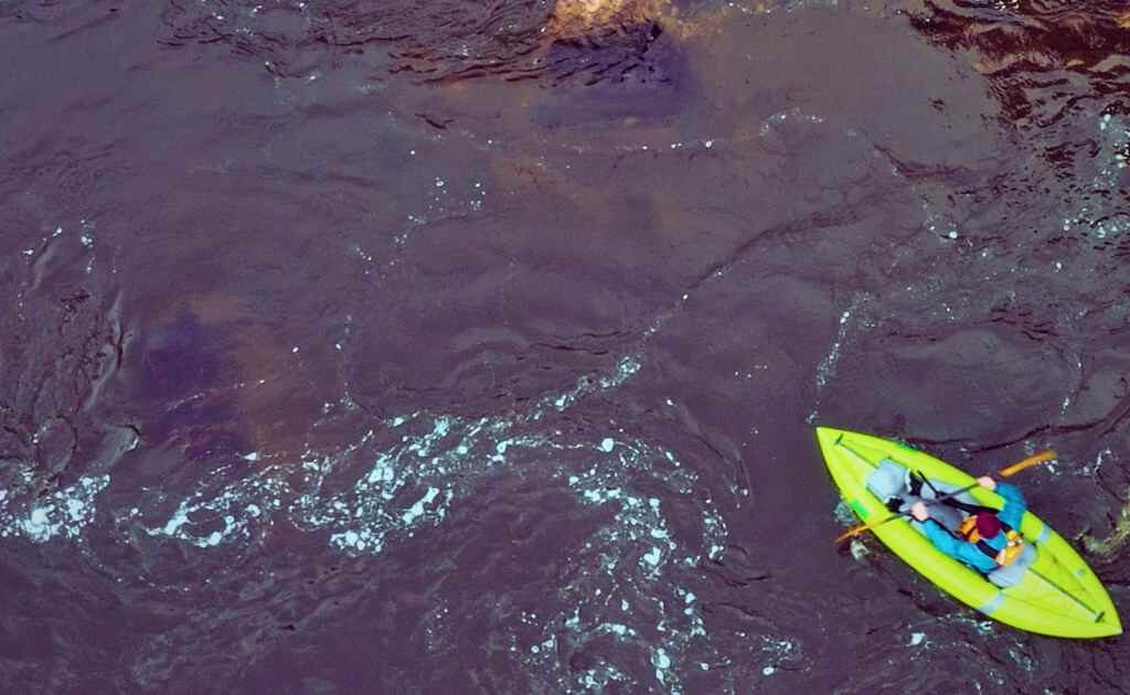 Ronin kayaking an inflatable kayak in the ocean, an explaining can you use an inflatable in the ocean or not.