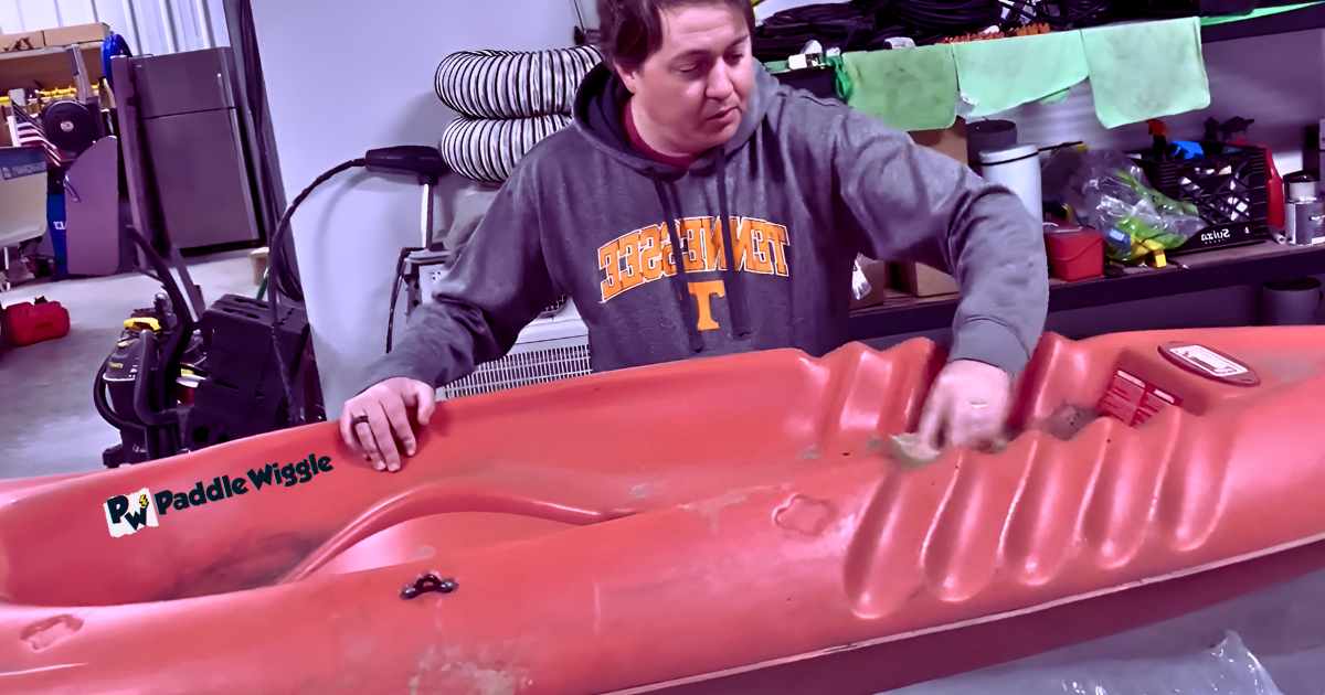 Sanding the surface of a kayak before painting